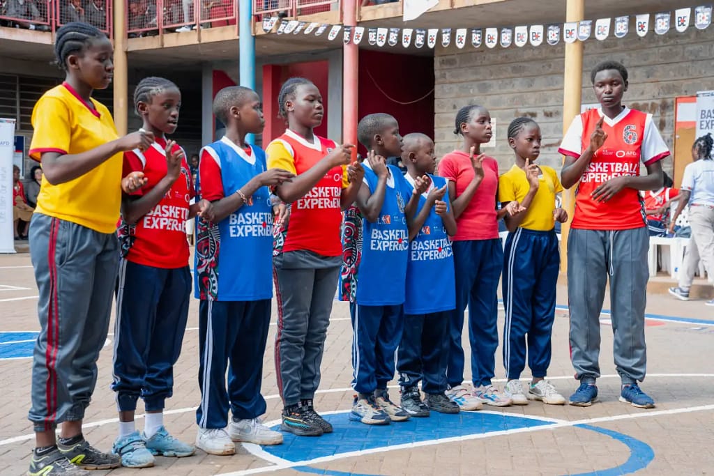 Basketball Experience Clinic for Deaf and Non-Deaf Students Lights Up Kinyanjui Road Primary School 2 A group of deaf students at Kinyanjui Road Primary School perform a poem in sign language during the basketball clinic