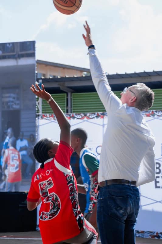 Basketball Experience Clinic for Deaf and Non-Deaf Students Lights Up Kinyanjui Road Primary School 5 German Ambassador, H.E Sebastian Groth, engages in a friendly basketball game with a student during the Basketball Experience Clinic at Kinyanjui Road Primary School.